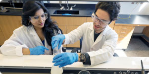 Photo of two students in a lab